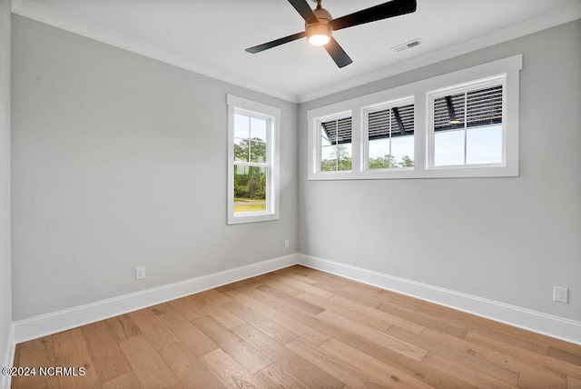 empty room featuring ornamental molding, light wood-type flooring, and ceiling fan