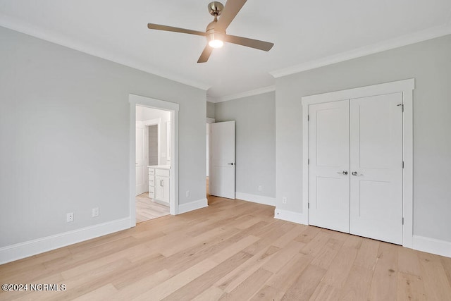 unfurnished bedroom featuring ensuite bath, a closet, light hardwood / wood-style floors, ceiling fan, and ornamental molding