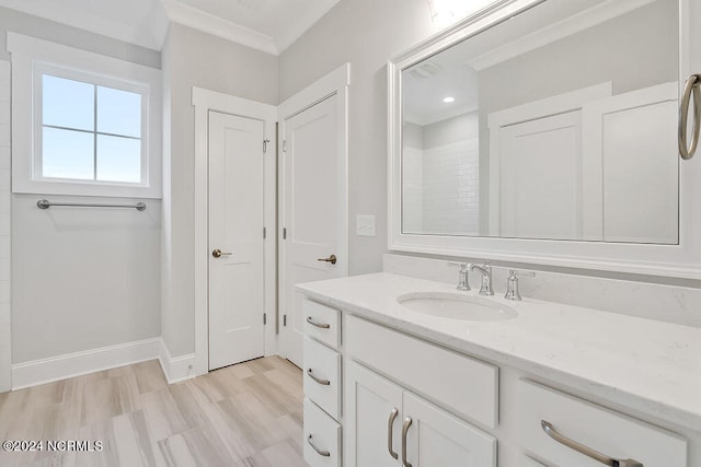 bathroom with vanity, crown molding, and wood-type flooring