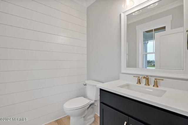 bathroom featuring toilet, hardwood / wood-style floors, and vanity