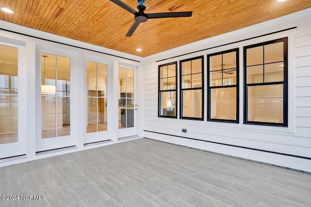 unfurnished sunroom with wood ceiling and ceiling fan