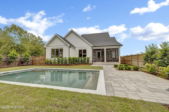 612 Waterstone Dr, Wilmington, NC 28411 - rear view of property with a sunroom, a fenced backyard, and a patio