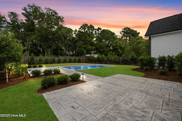 612 Waterstone Dr, Wilmington, NC 28411 - pool at dusk with a patio, a fenced backyard, and view of scattered trees