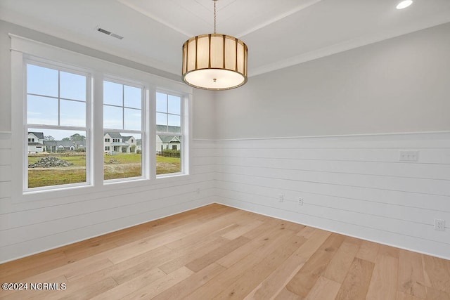 spare room featuring wooden walls and hardwood / wood-style flooring