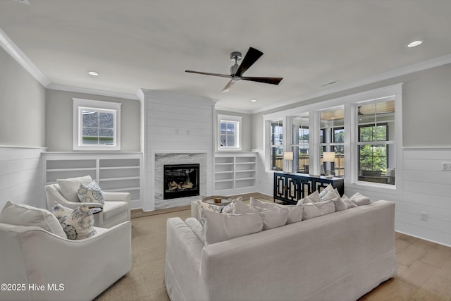 612 Waterstone Dr, Wilmington, NC 28411 - living room with crown molding, a ceiling fan, healthy amount of natural light, wood finished floors, and a wainscoted wall