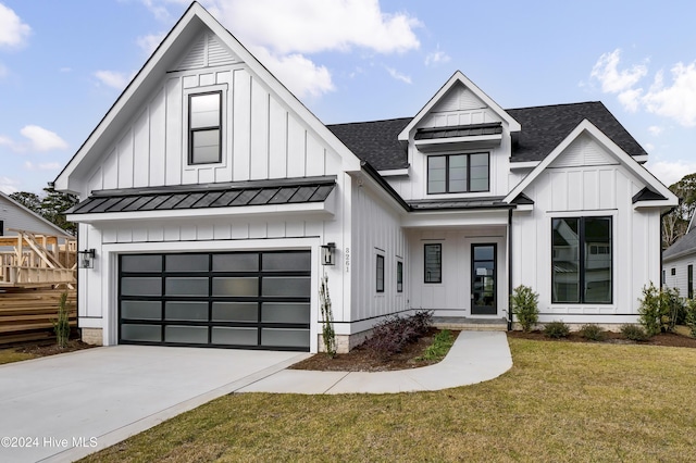 modern inspired farmhouse with a front lawn and a garage