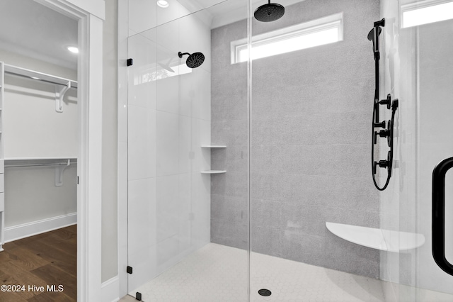 bathroom featuring hardwood / wood-style floors and a shower with door