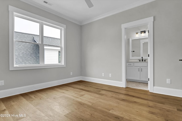 unfurnished bedroom featuring sink, crown molding, ceiling fan, connected bathroom, and light hardwood / wood-style floors