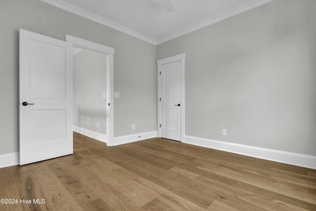 unfurnished room featuring light wood-type flooring and ornamental molding