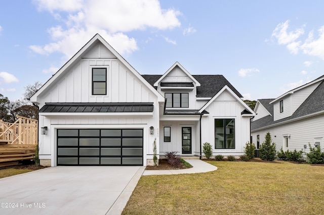 modern inspired farmhouse with driveway, a shingled roof, a standing seam roof, a front lawn, and board and batten siding