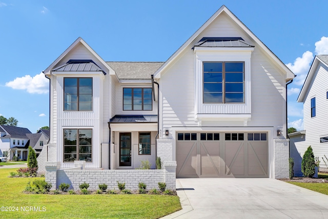 modern farmhouse style home with a front yard and a garage