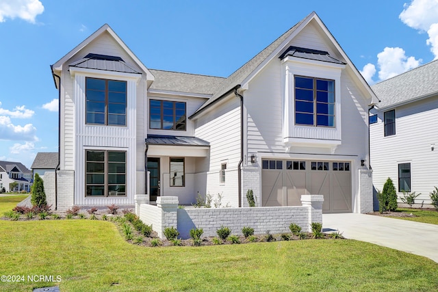 view of front of home featuring a front yard and a garage