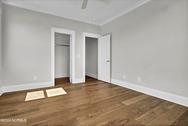 unfurnished bedroom with a closet, ceiling fan, crown molding, and hardwood / wood-style floors