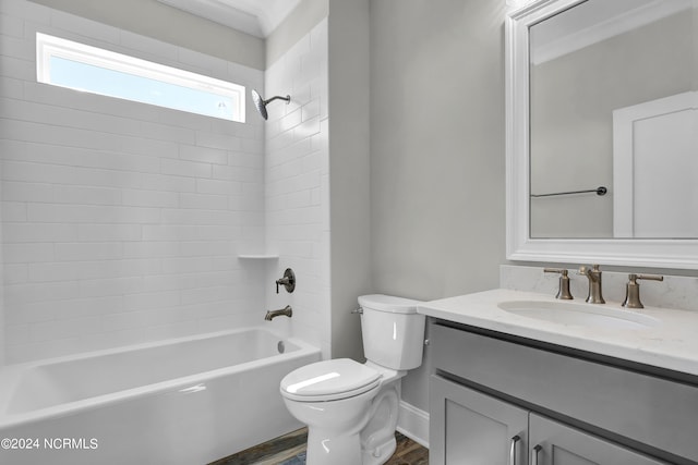 full bathroom with vanity, tiled shower / bath, toilet, and wood-type flooring