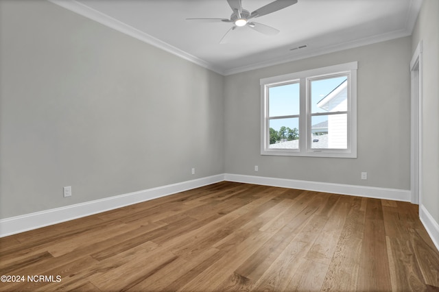 spare room with ornamental molding, wood-type flooring, and ceiling fan