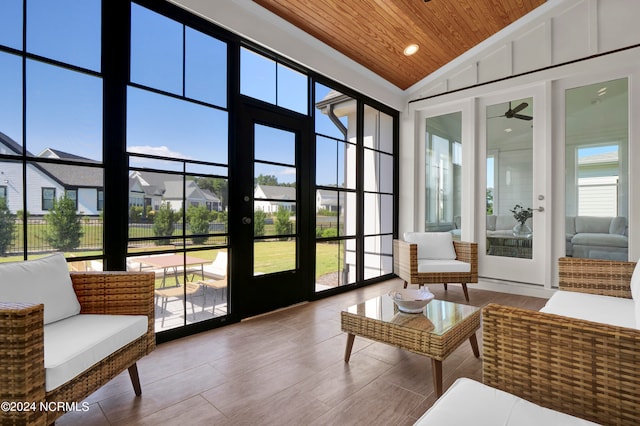 sunroom / solarium with lofted ceiling, ceiling fan, and wooden ceiling