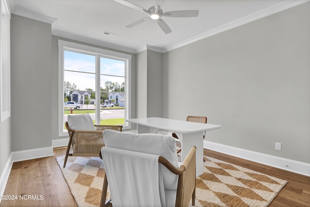 dining area with light hardwood / wood-style flooring, ceiling fan, and crown molding