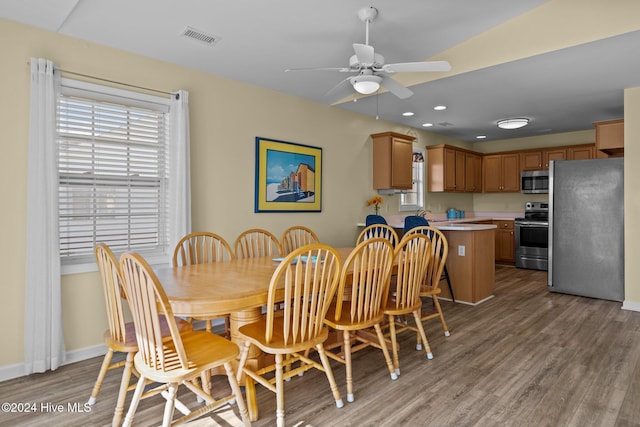 dining space with hardwood / wood-style flooring and ceiling fan