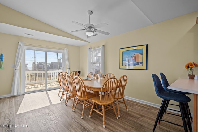 dining space featuring vaulted ceiling, hardwood / wood-style flooring, and ceiling fan