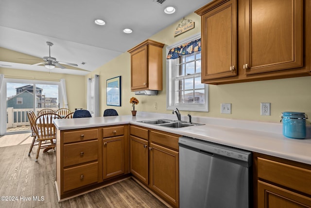 kitchen featuring sink, dishwasher, kitchen peninsula, and dark hardwood / wood-style floors