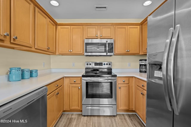 kitchen featuring appliances with stainless steel finishes and light hardwood / wood-style floors