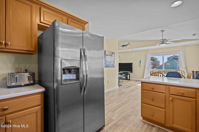 kitchen with ceiling fan, lofted ceiling, light wood-type flooring, and stainless steel fridge