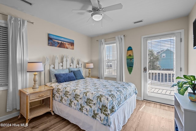 bedroom featuring access to exterior, wood-type flooring, and ceiling fan