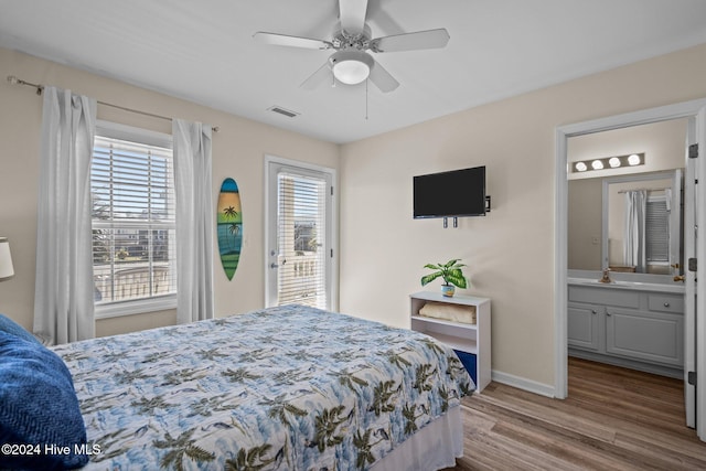 bedroom featuring ceiling fan, ensuite bathroom, sink, and hardwood / wood-style floors