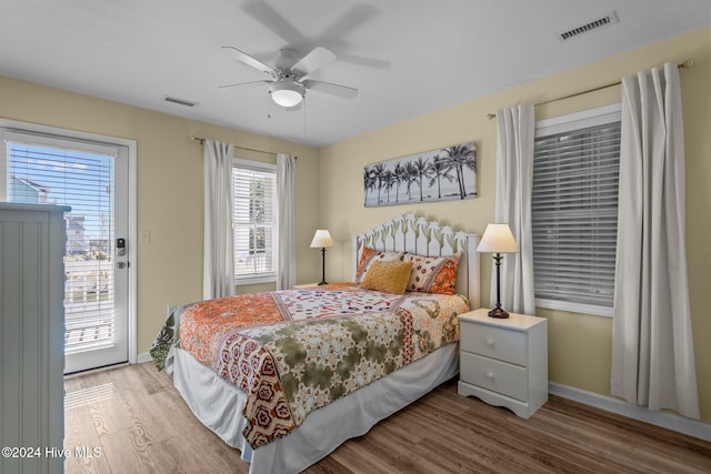 bedroom featuring access to exterior, light wood-type flooring, and ceiling fan