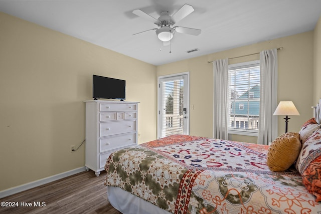 bedroom with dark hardwood / wood-style floors and ceiling fan