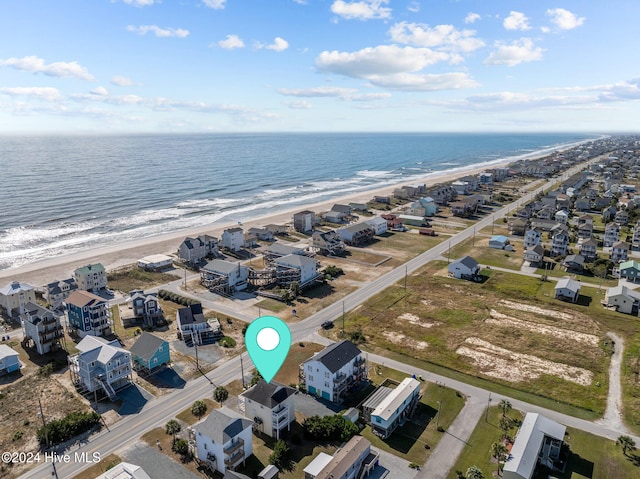 drone / aerial view with a water view and a beach view