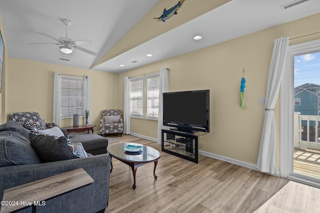 living room with light hardwood / wood-style flooring, lofted ceiling, and ceiling fan