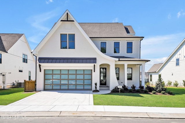 modern inspired farmhouse featuring a garage, a front lawn, and central AC unit