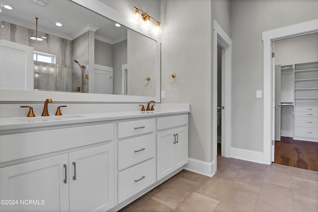 bathroom with vanity, tile patterned floors, ornamental molding, and walk in shower