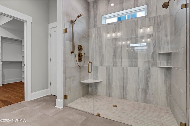 bathroom with an enclosed shower and hardwood / wood-style floors