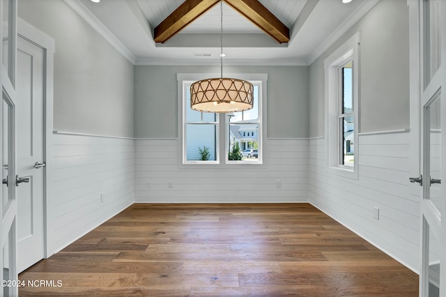 unfurnished room with beamed ceiling, a healthy amount of sunlight, and dark hardwood / wood-style flooring