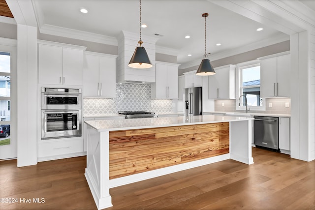 kitchen featuring a center island, appliances with stainless steel finishes, dark hardwood / wood-style floors, and white cabinetry