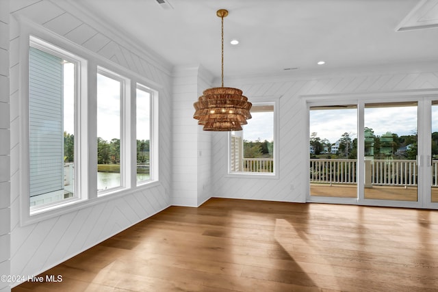 interior space featuring wooden walls, wood-type flooring, and plenty of natural light