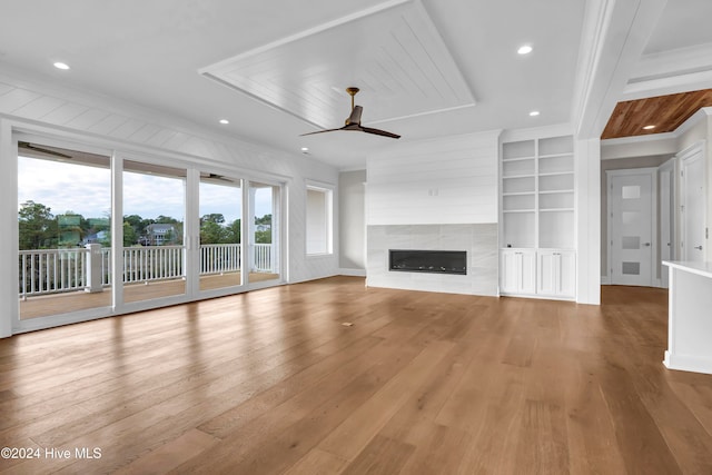 unfurnished living room with crown molding, light hardwood / wood-style flooring, a fireplace, and ceiling fan