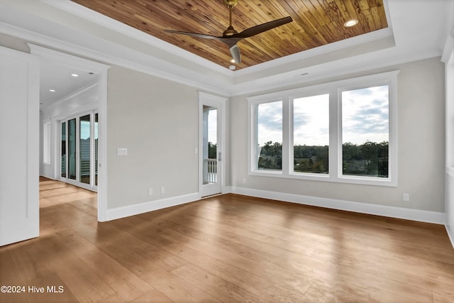 unfurnished room with ceiling fan, wood ceiling, a tray ceiling, and hardwood / wood-style floors