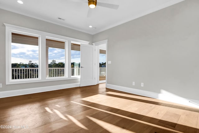 empty room with hardwood / wood-style floors and ceiling fan