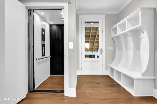 mudroom with elevator and hardwood / wood-style flooring