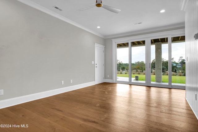 spare room with hardwood / wood-style floors, crown molding, and ceiling fan