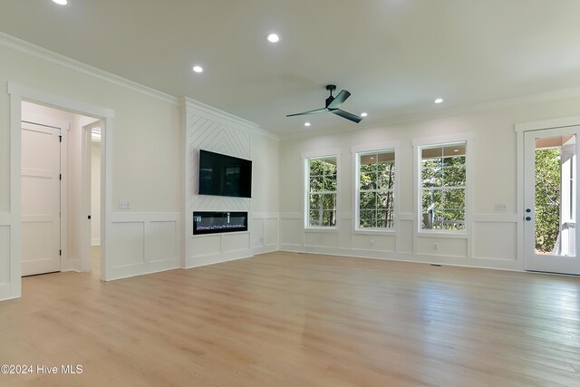 unfurnished living room featuring ornamental molding, light hardwood / wood-style floors, and ceiling fan