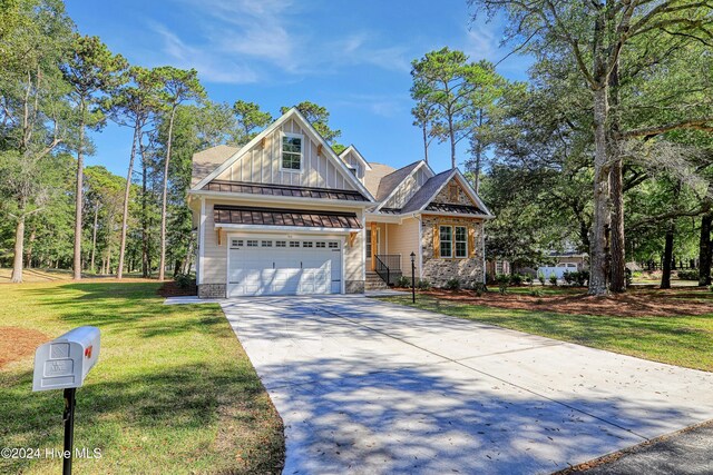 craftsman inspired home with a front lawn and a garage