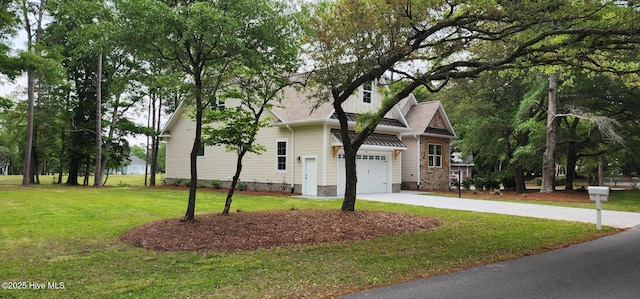 view of front of property with a front lawn and concrete driveway