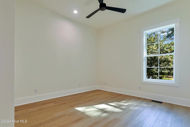 empty room with light hardwood / wood-style floors and ceiling fan