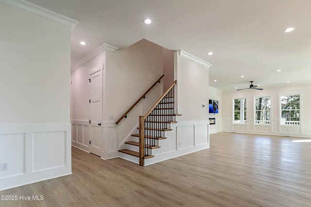 living room featuring light hardwood / wood-style flooring, ceiling fan, and sink