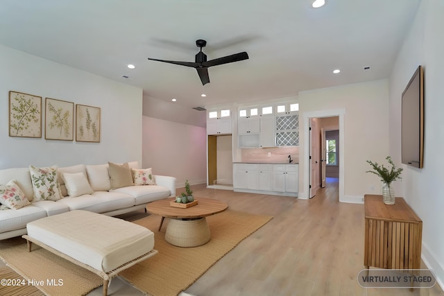 kitchen with white cabinets, light hardwood / wood-style floors, beverage cooler, and backsplash