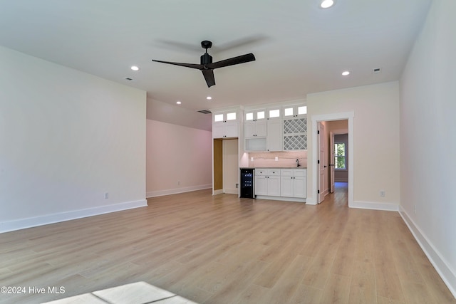 unfurnished living room with recessed lighting, light wood-style flooring, baseboards, and ceiling fan